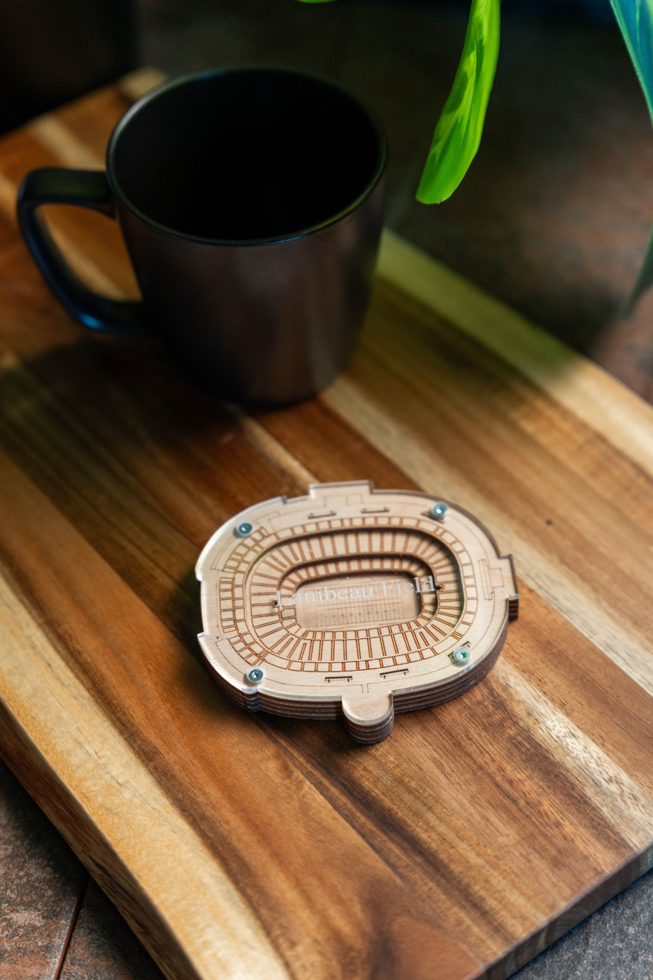 Layered 3D Lambeau Field keepsake beside a coffee mug