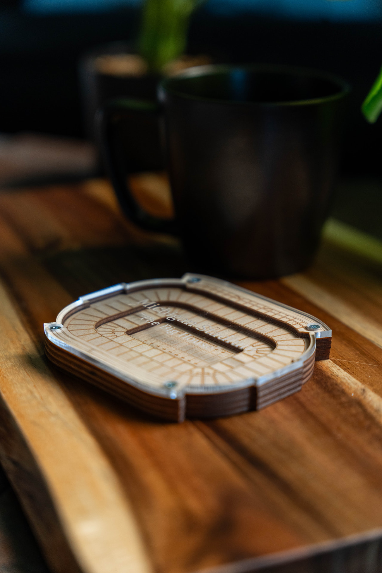Layered 3D Michigan Stadium keepsake on a wooden counter